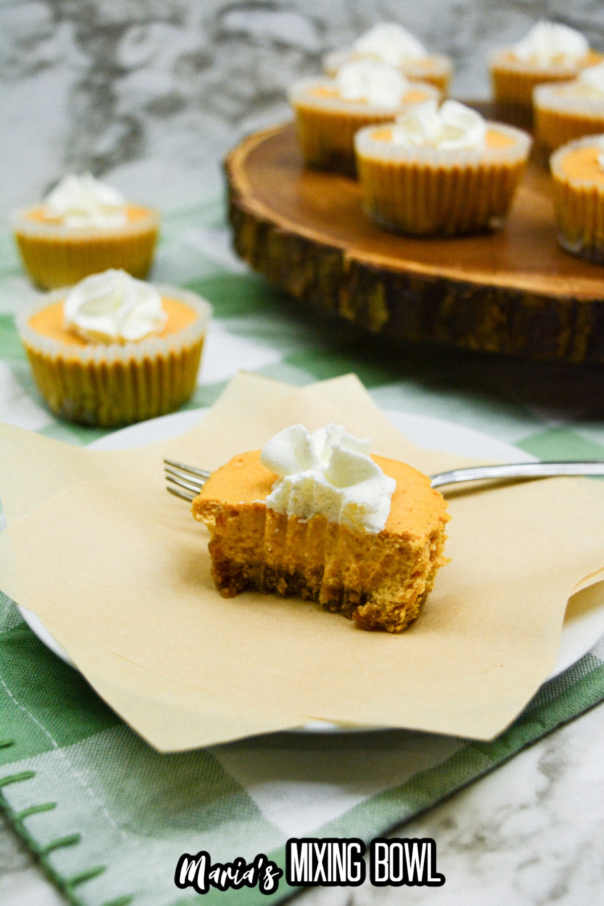 mini pumpkin pie cheesecake on a plate cut in half.