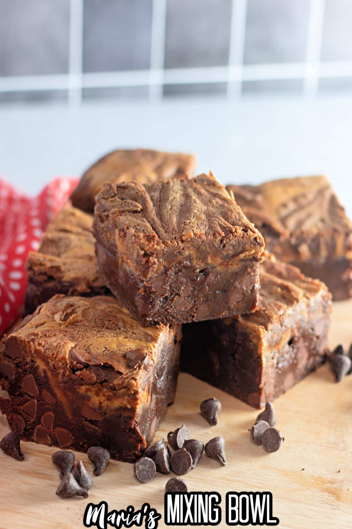 peanut butter chocolate chip brownies stacked on a counter.