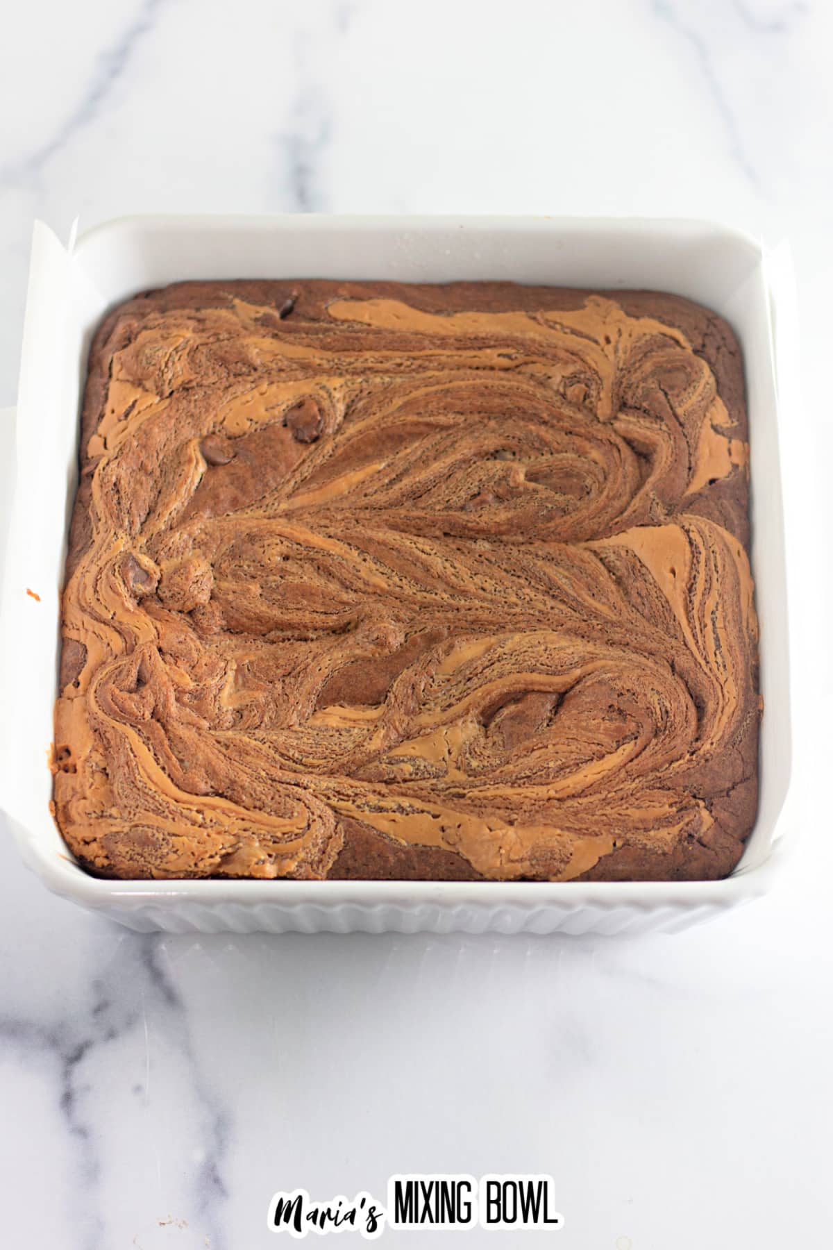 baked peanut butter chocolate brownies uncut in a baking dish.