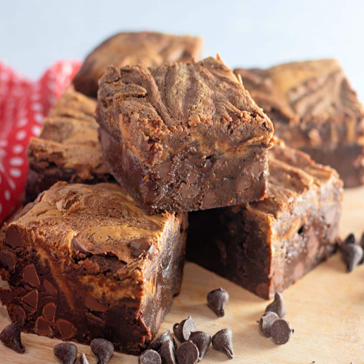 peanut butter chocolate chip brownies stacked on a counter.