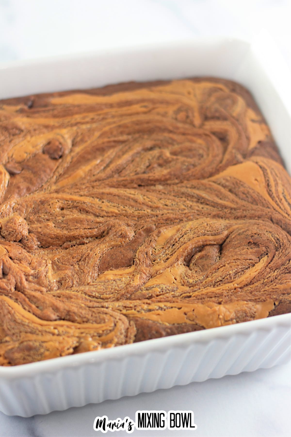 baked brownies in a square casserole dish.