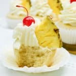 pina colada cupcake with a bite missing to see the inside.