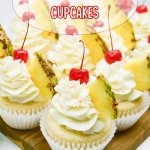 pina colada cupcakes on a wooden cutting board.