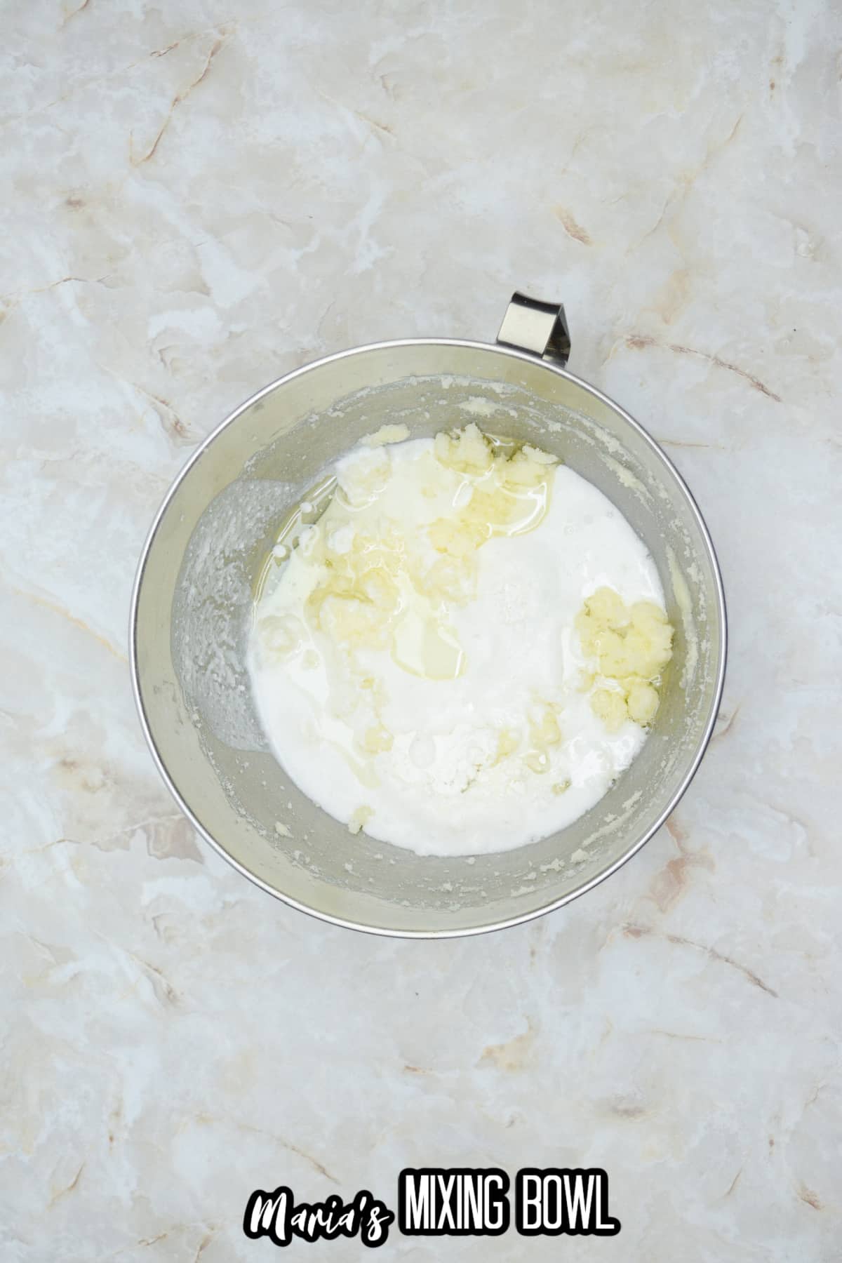 coconut milk, rum extract and sugar in a stainless steel mixing bowl.