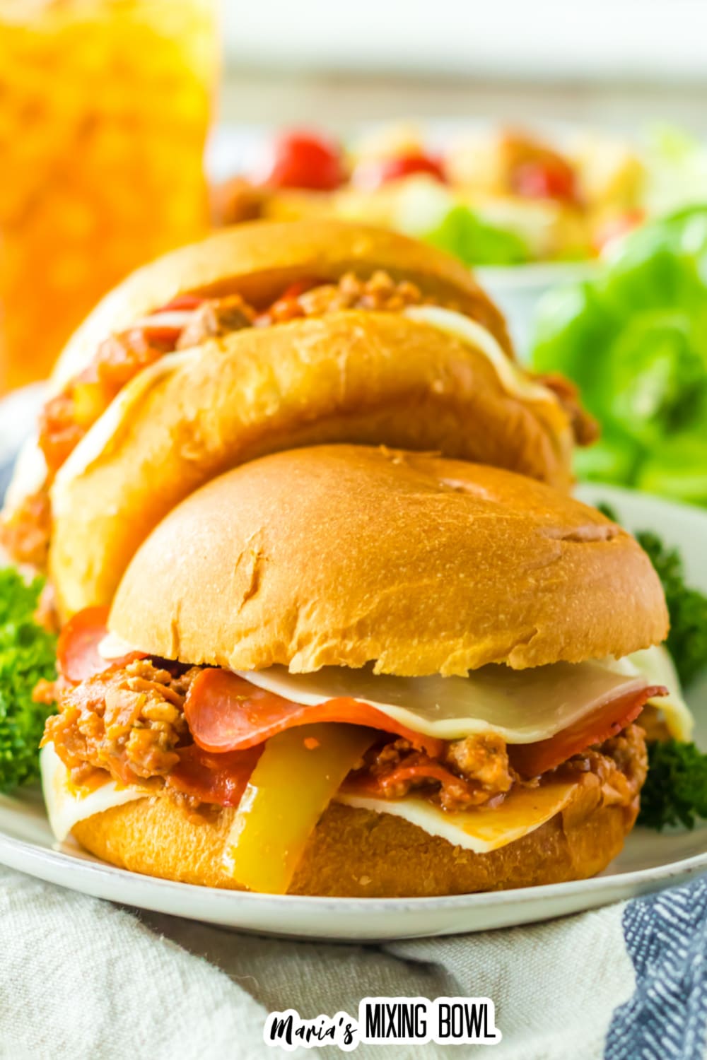 two slow cooker pizza sloppy joes on a white plate.