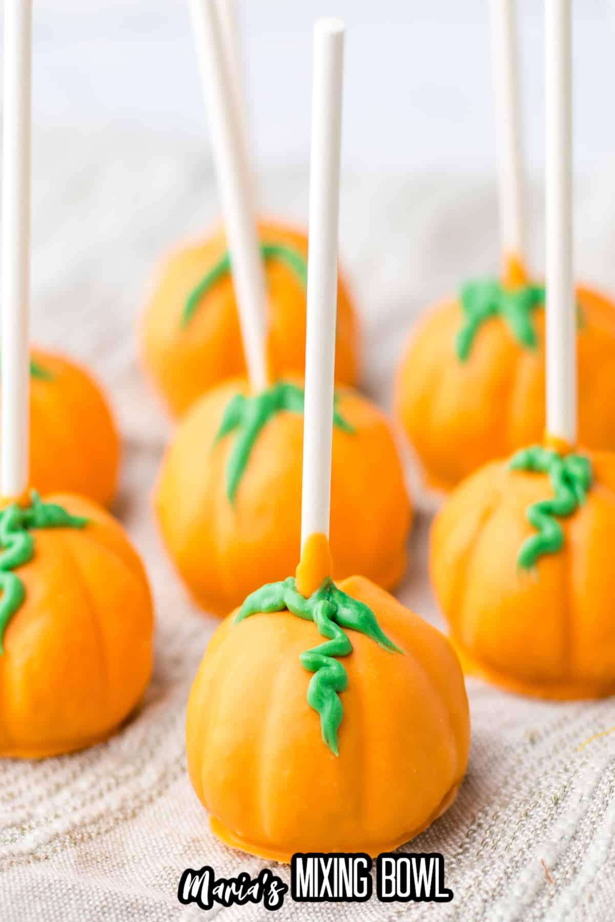 pumpkin oreo truffles on a kitchen towels.
