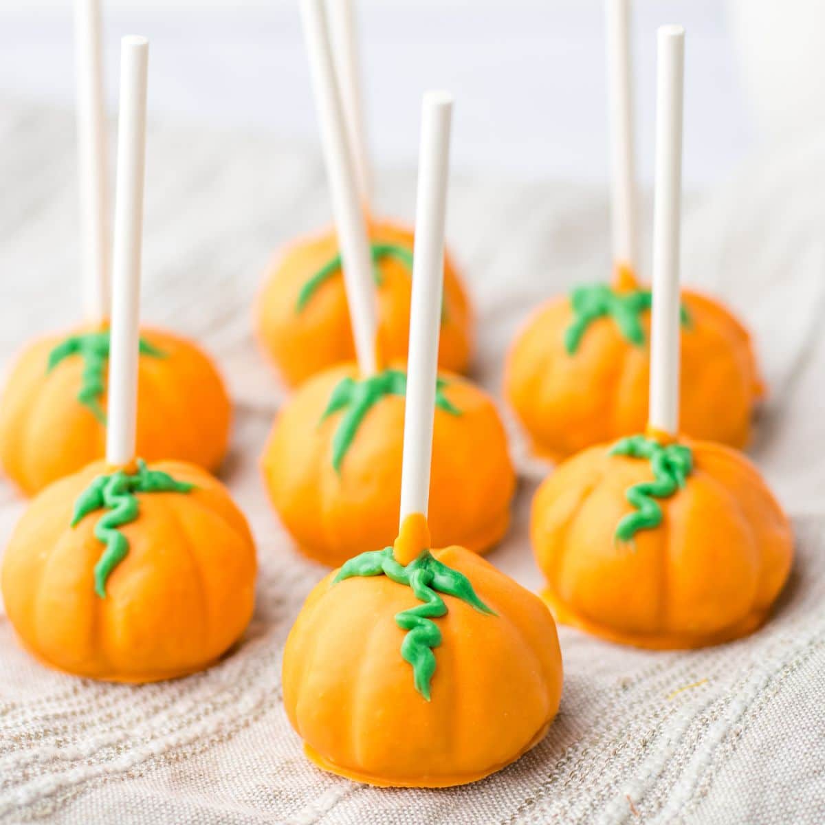 pumpkin oreo truffles on a kitchen towels.