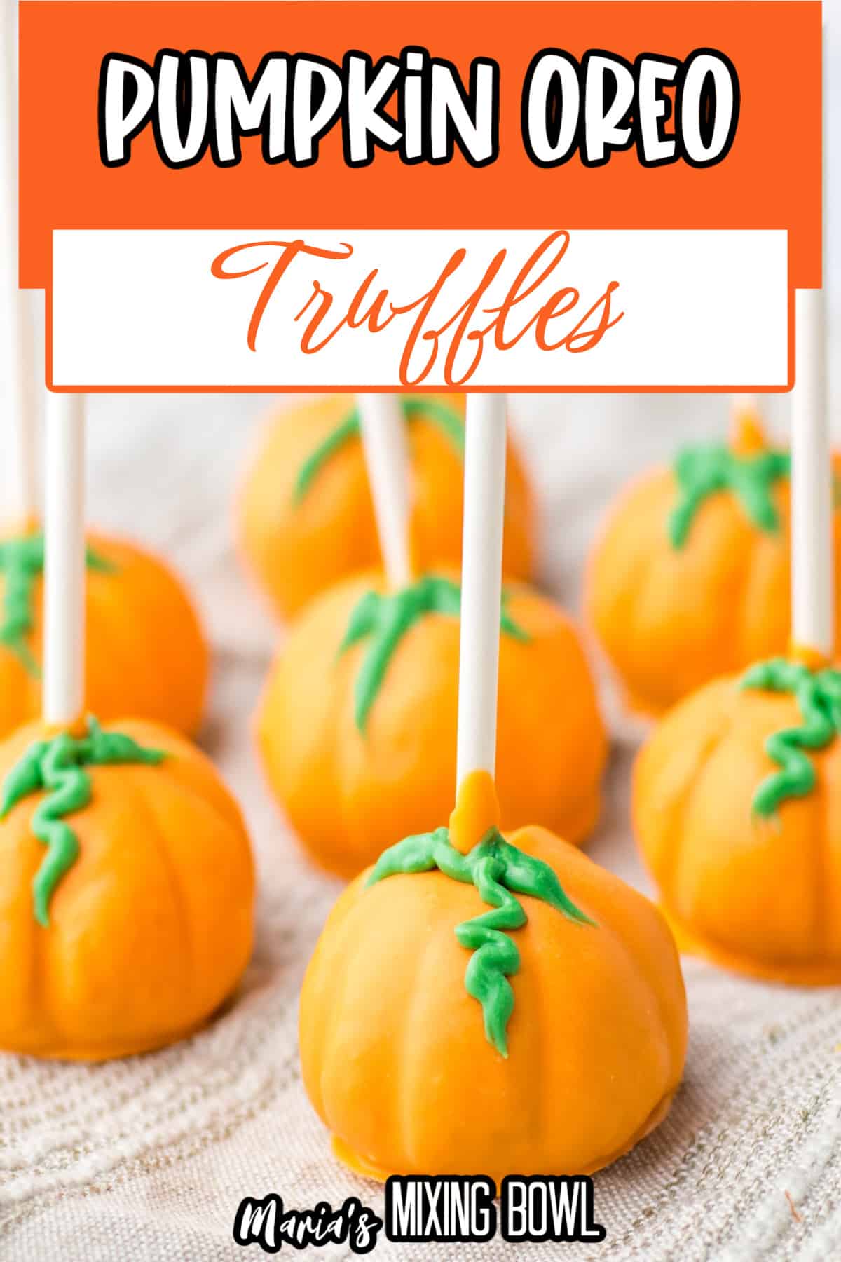 pumpkin oreo truffles on a kitchen towels.