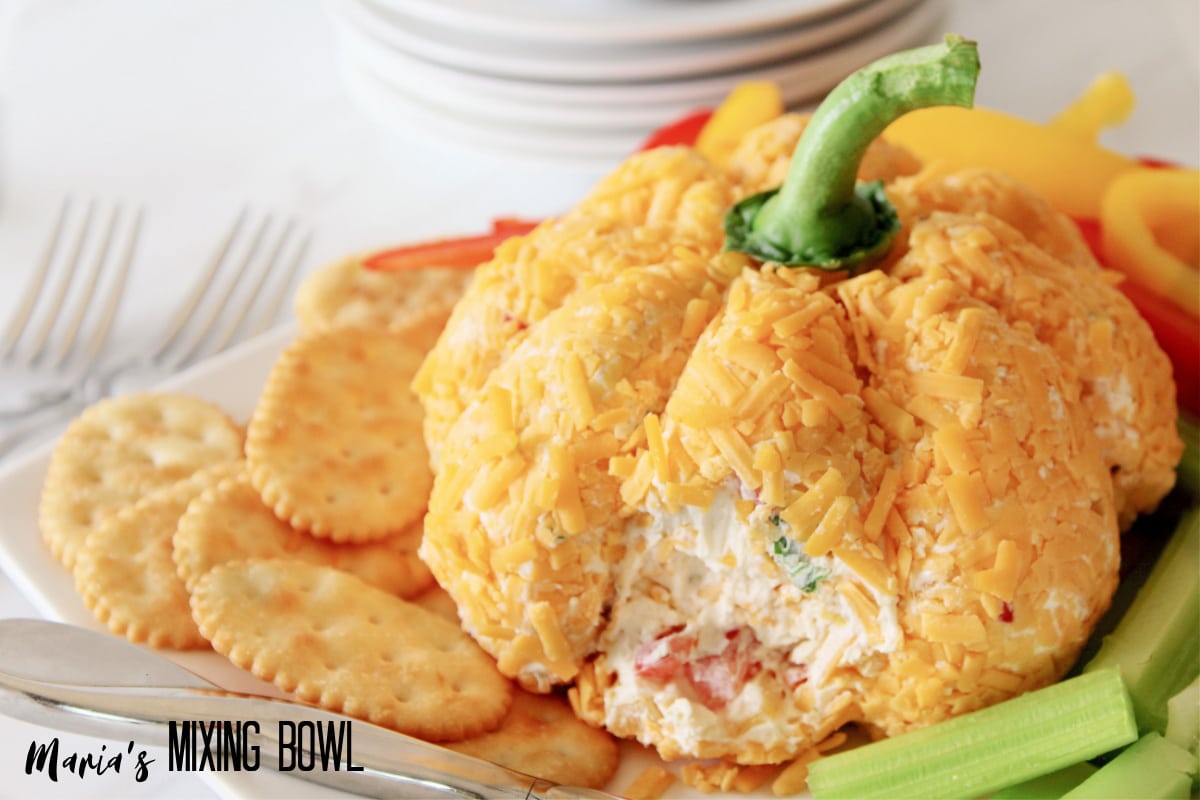 cheese ball with a small amount missing to show the inside.
