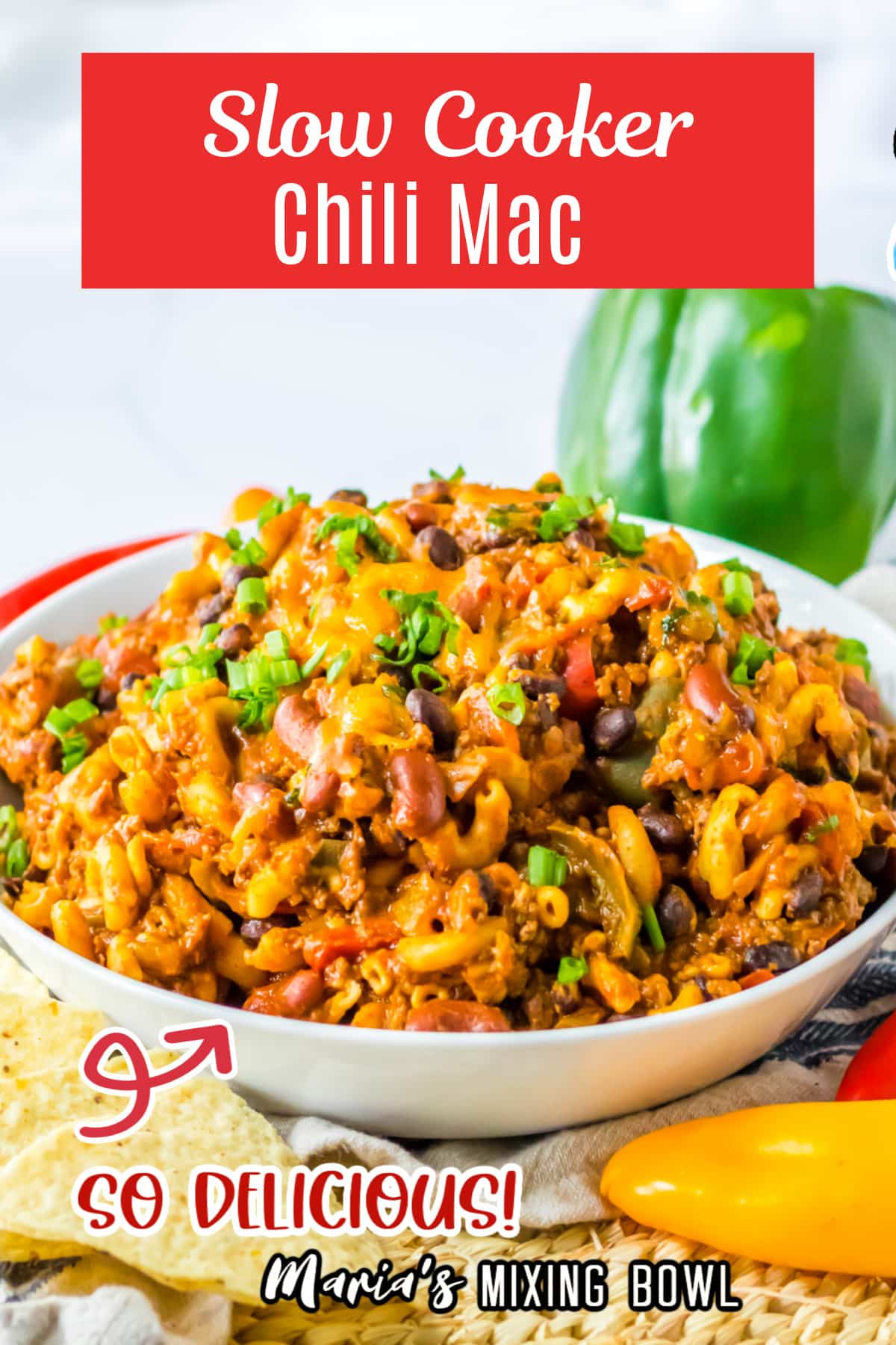 bowl full of chili mac garnished with green onions.