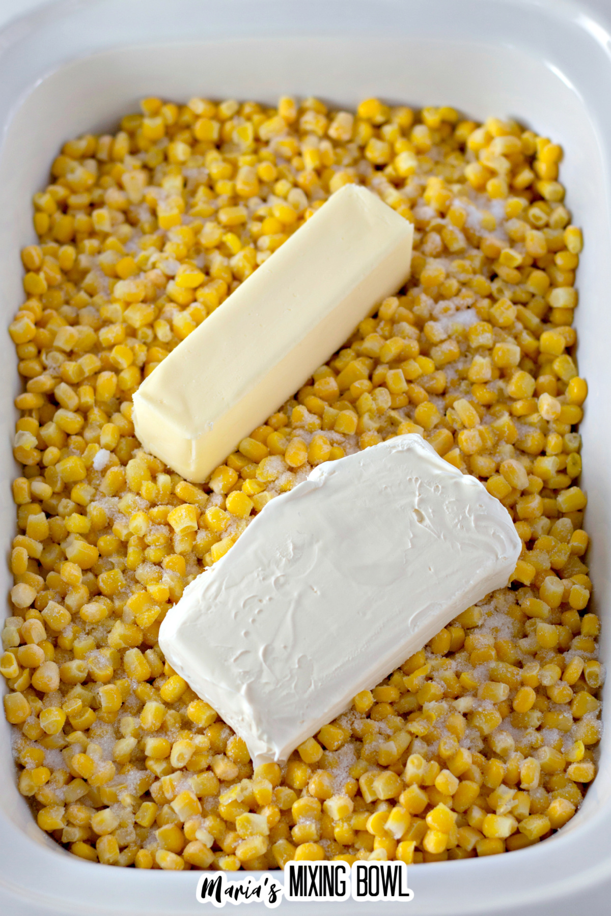 frozen corn, sugar, salt, cream cheese, and butter in a slow cooker.