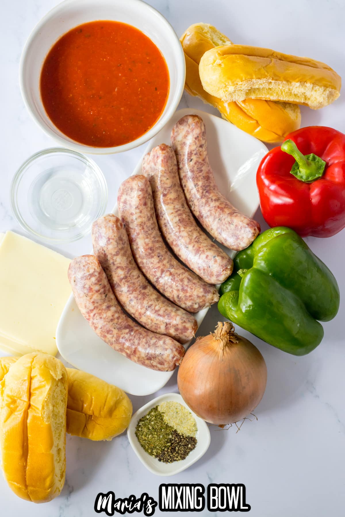 bowl of tomato sauce, sausages, hoagie rolls, seasonings, onion, green bell pepper and red bell peppers.
