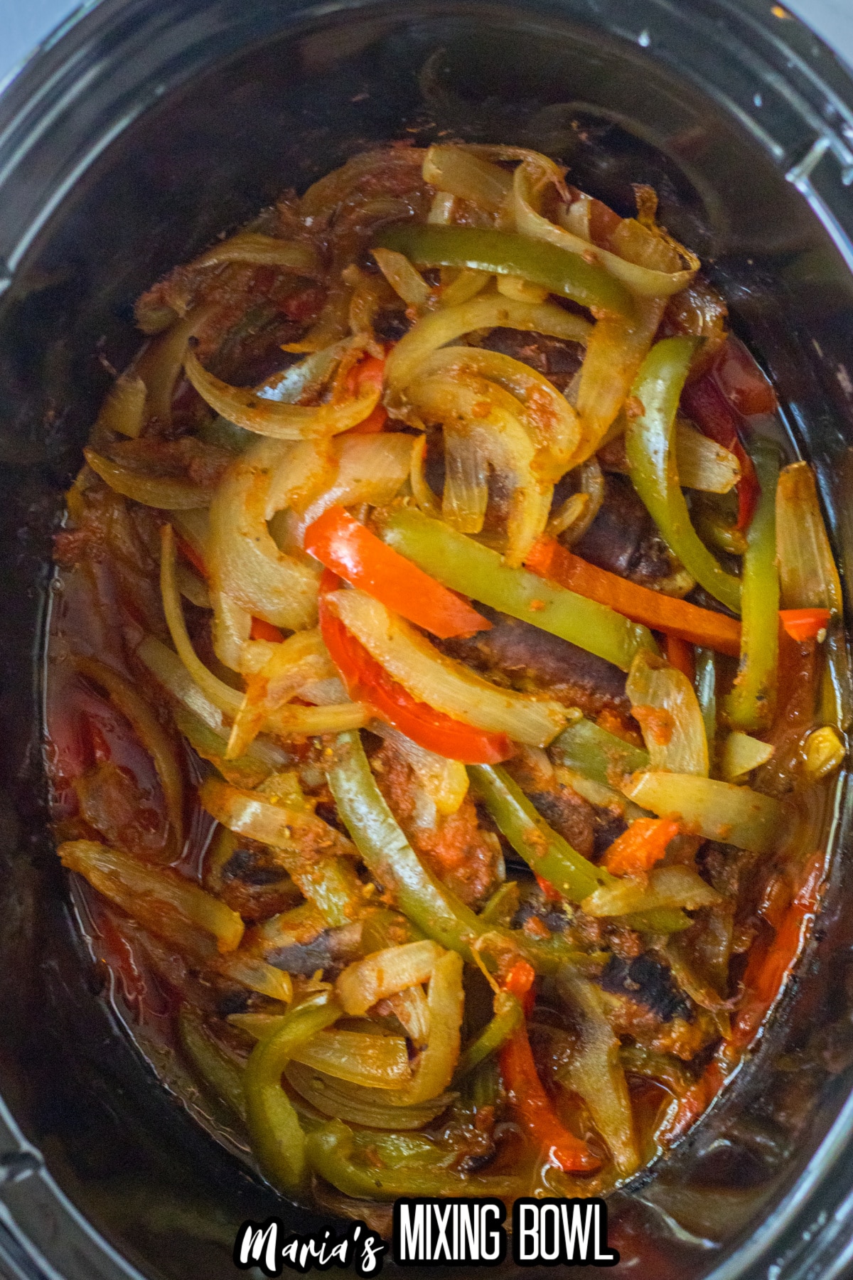 cooked sausage peppers and onions in a slow cooker.