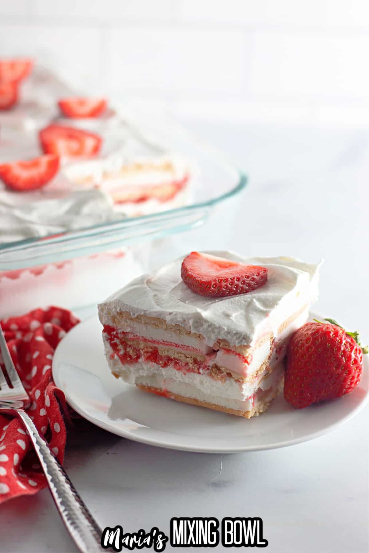 slice of strawberry ice cream cake on a plate.