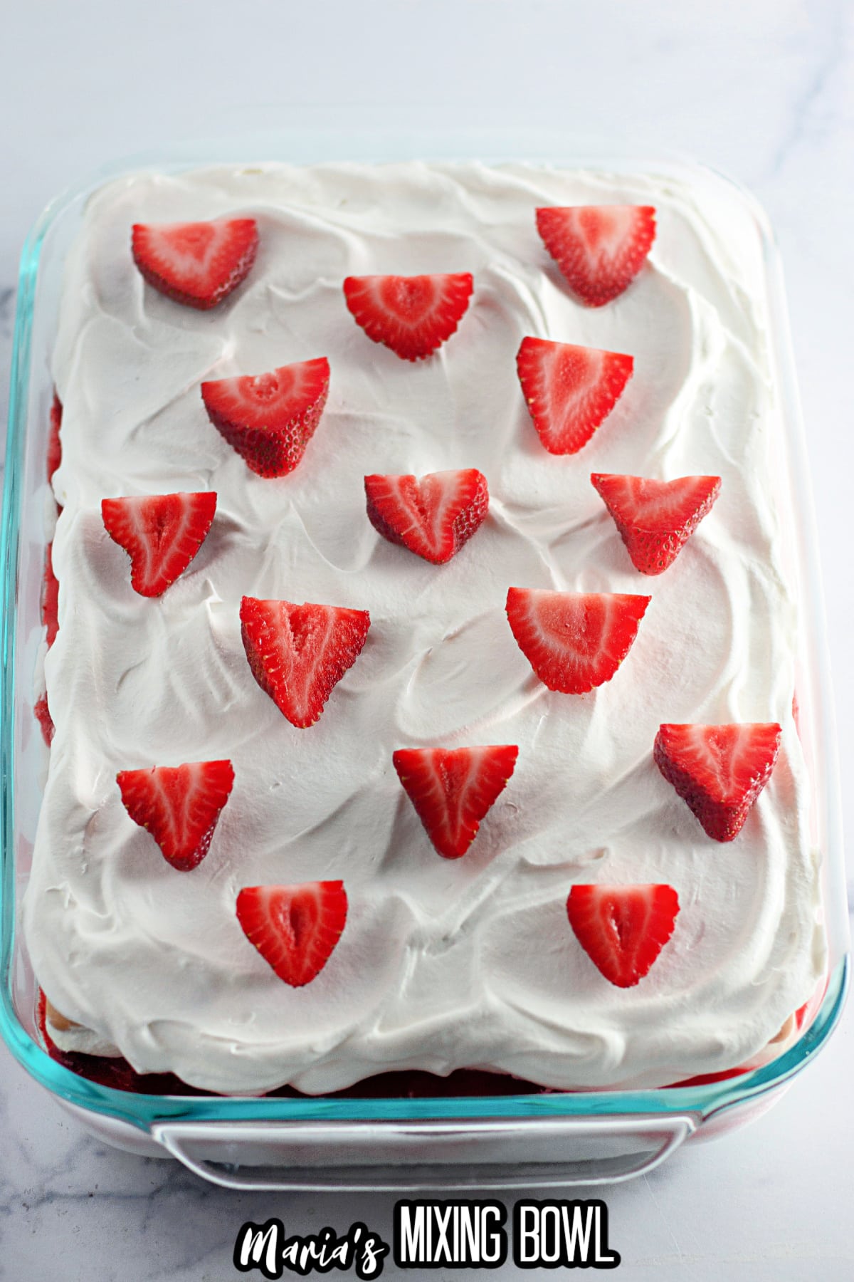 finished strawberry ice cream cake in a glass baking dish.