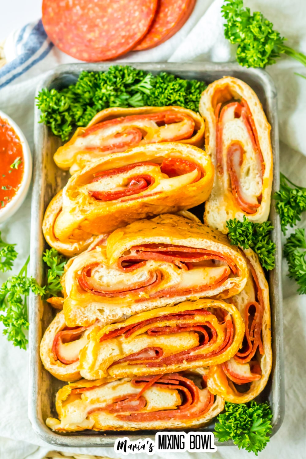 slices of stuffed pepperoni bread on a metal serving tray.