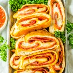 slices of stuffed pepperoni bread on a metal serving tray.