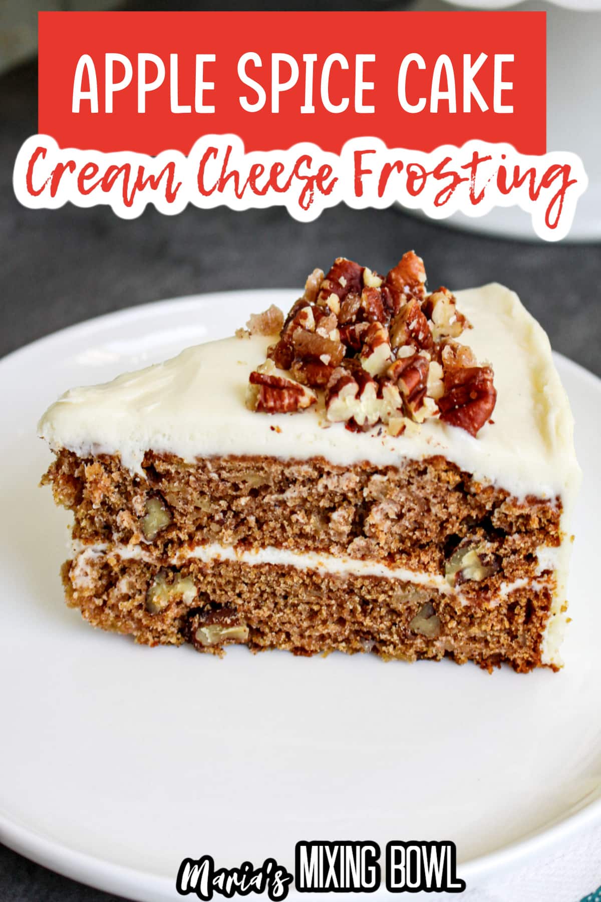 slice of apple spice cake topped with cream cheese frosting on a white plate.