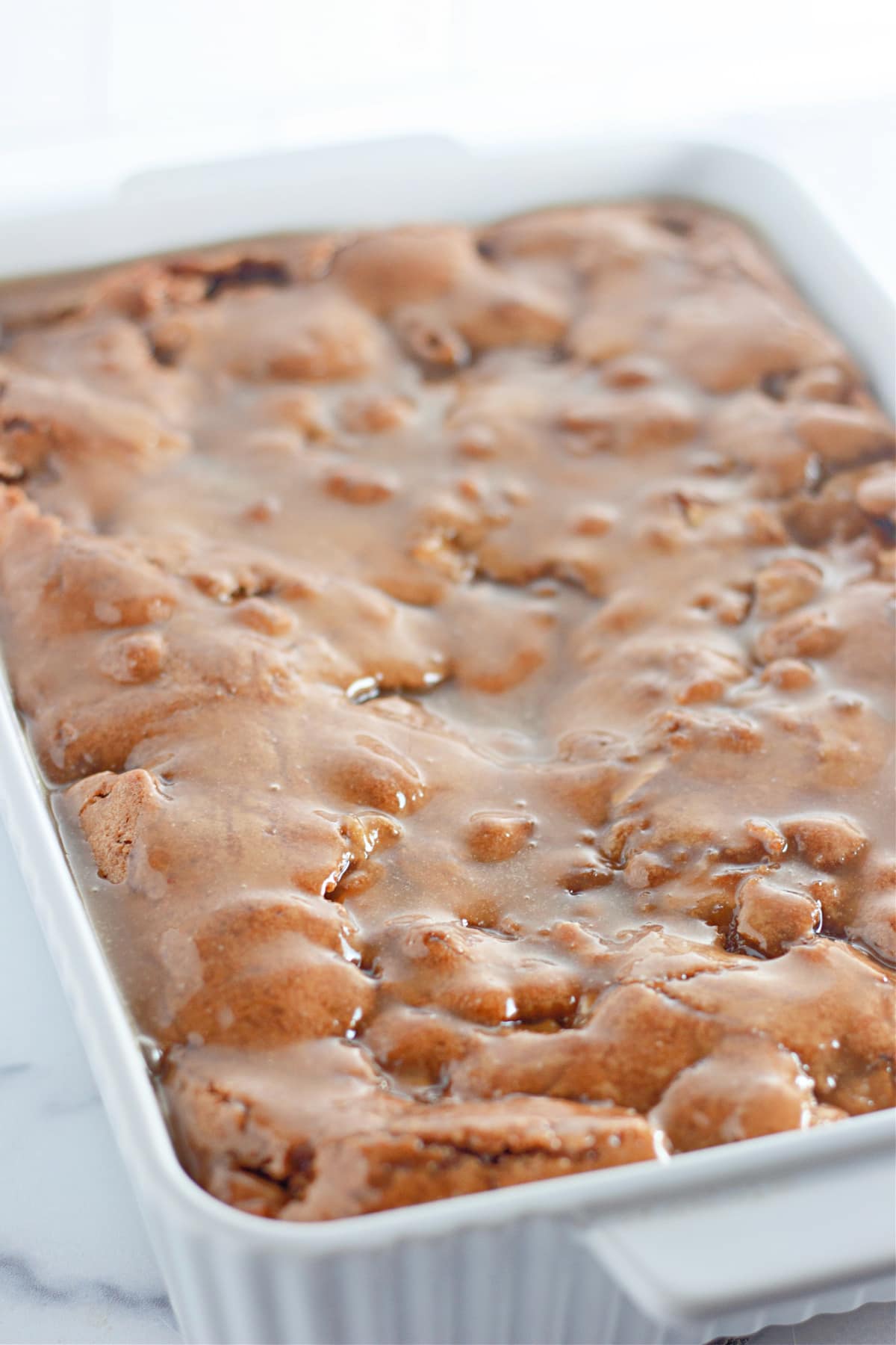 uncut apple dapple cake in a baking dish.