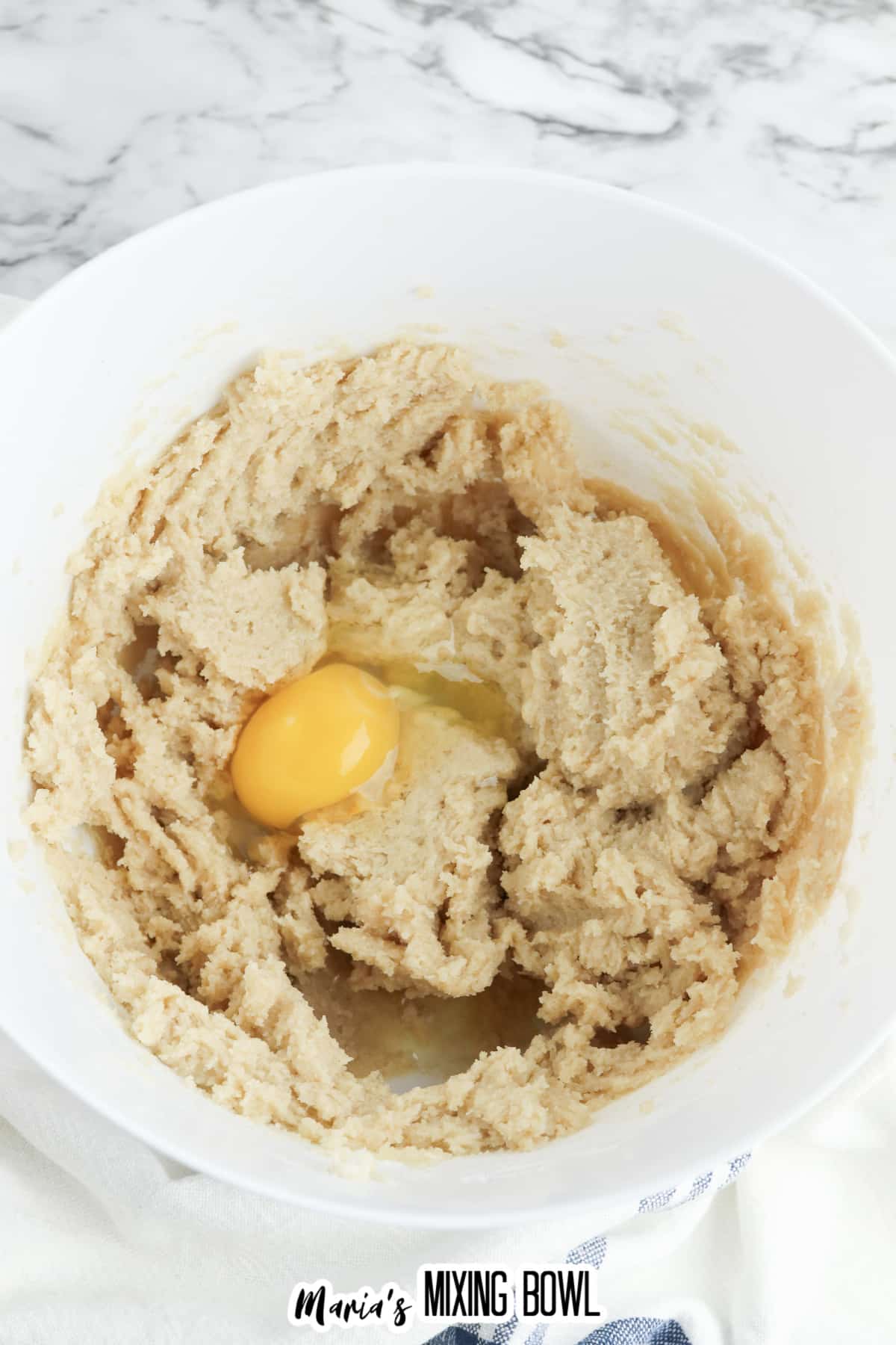 brown sugar, granulated sugar, eggs and butter being mixed in bowl.