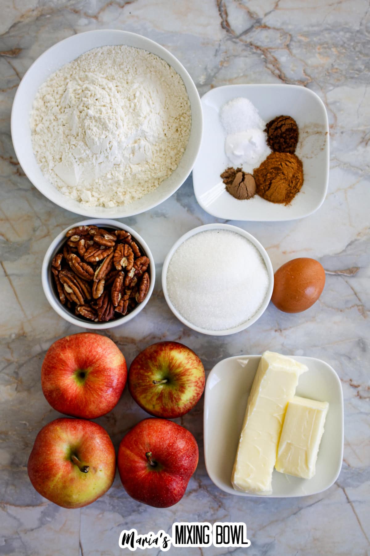 bowls of flour, salt, spices, sugar, pecans, butter, egg, and apples.