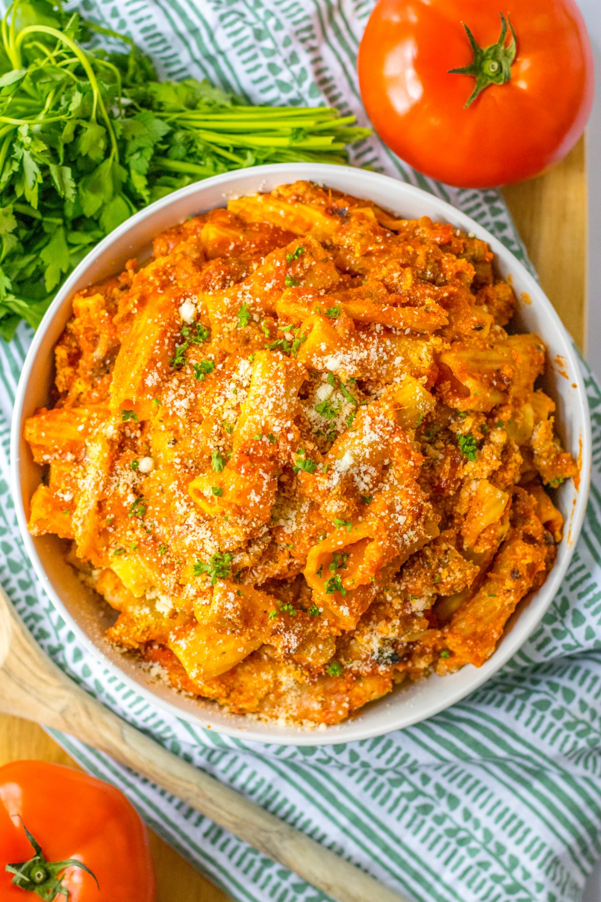 bowl full of slow cooker baked ziti topped with grated parmesan cheese.