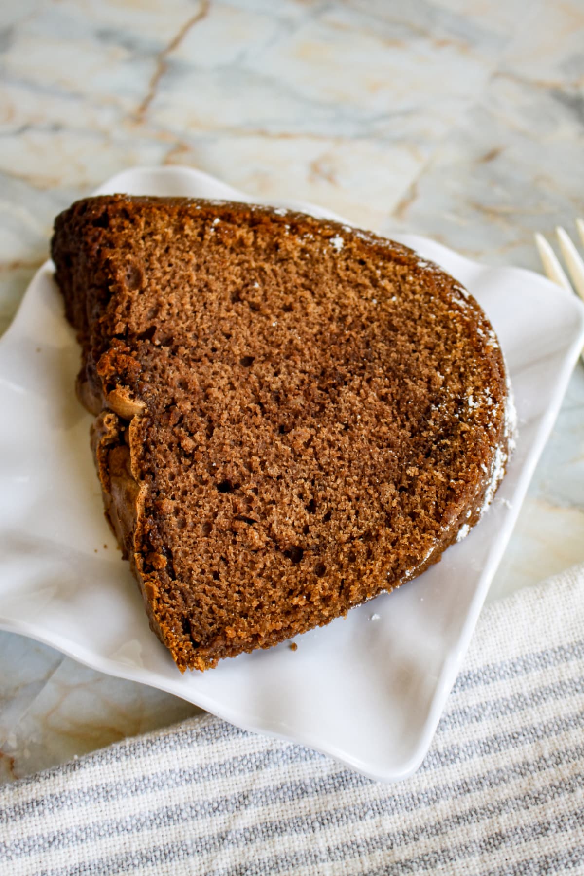 slice of buttermilk chocolate bundt cake on a plate.