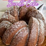 uncut bundt cake on a wooden cutting board.