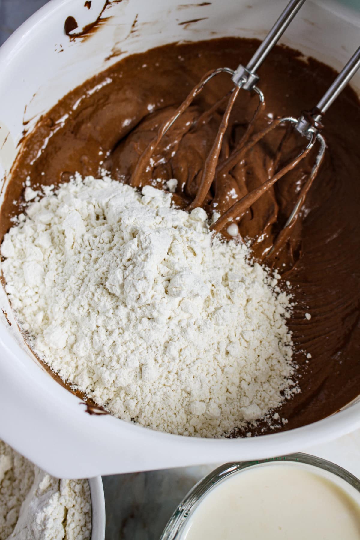 cake batter being mixed a in large mixing bowl.