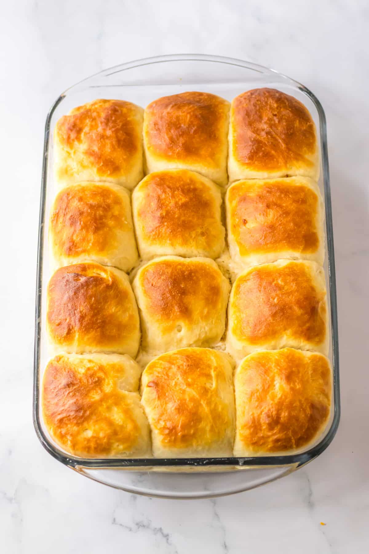 baked cafeteria rolls in a glass baking dish.