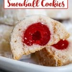 cherry snowball cookie broken open in half to show the cherry on the inside.