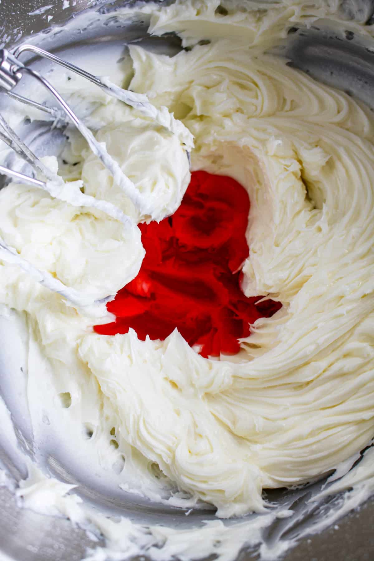 butter, and sugar, and cherry juice being mixed in a mixing bowl.