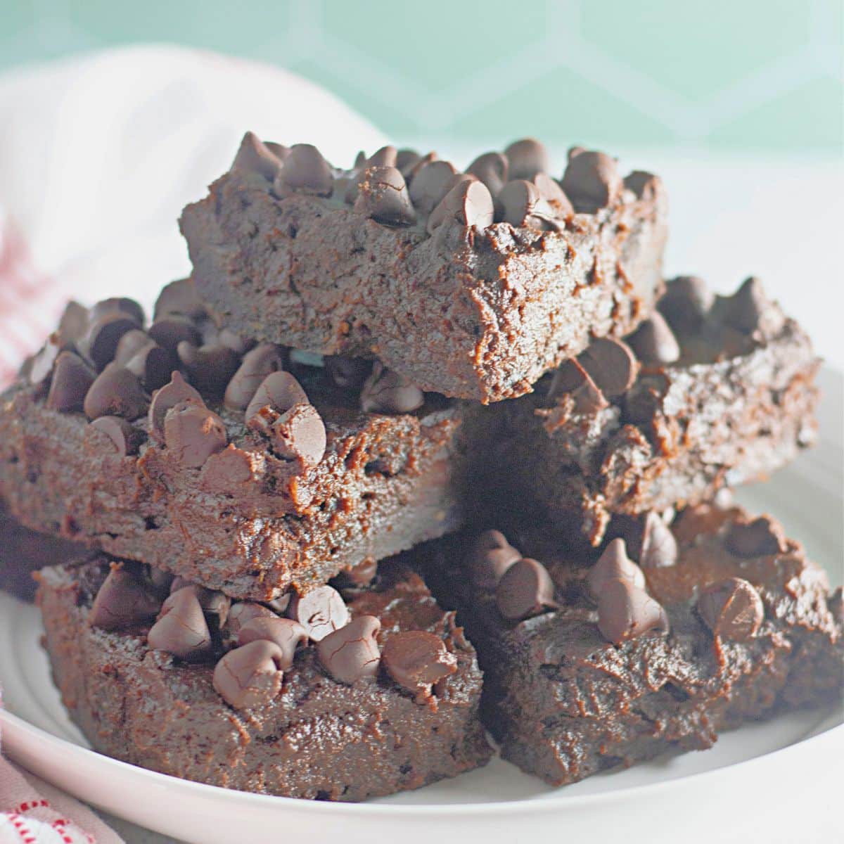 stack of chocolate pumpkin brownies on a plate.