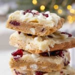four cranberry bliss bars stacked on top of each other.