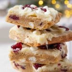 Copycat Cranberry Bliss Bars four cranberry bliss bars stacked on top of each other.
