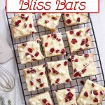 cranberry bliss bars decorated and cut on a wire rack.