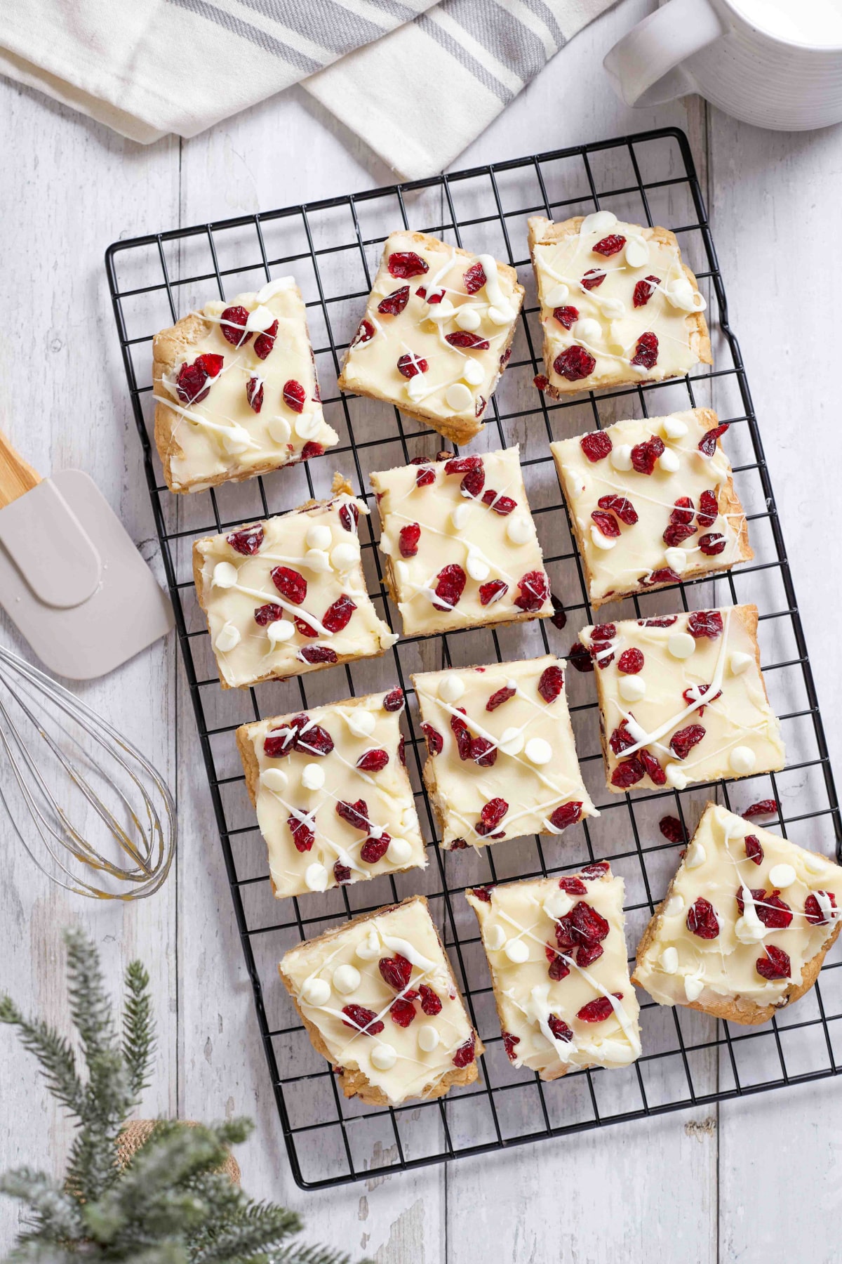 cranberry bliss bars decorated and cut on a wire rack.