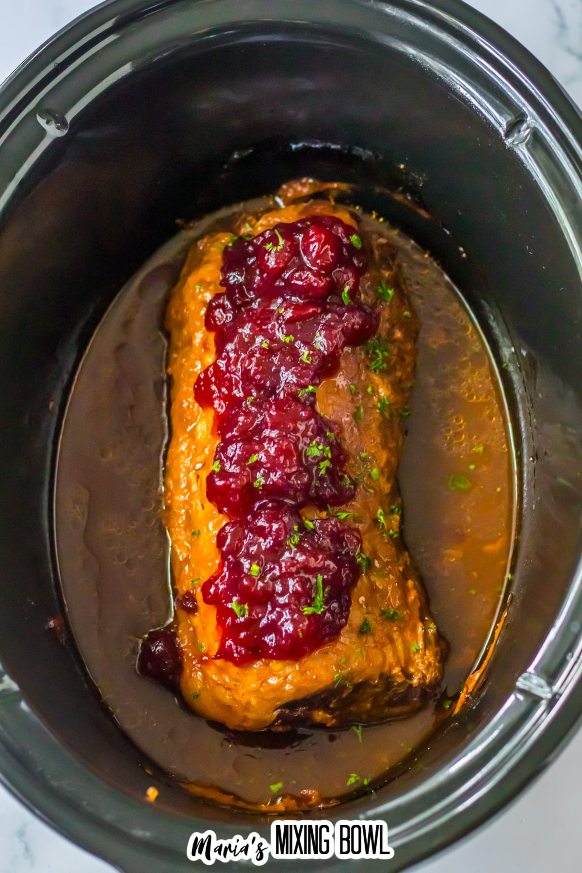 cooked cranberry pork loin in the slow cooker.
