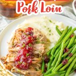 cranberry roast pork loin on a plate with mashed potatoes and green beans.