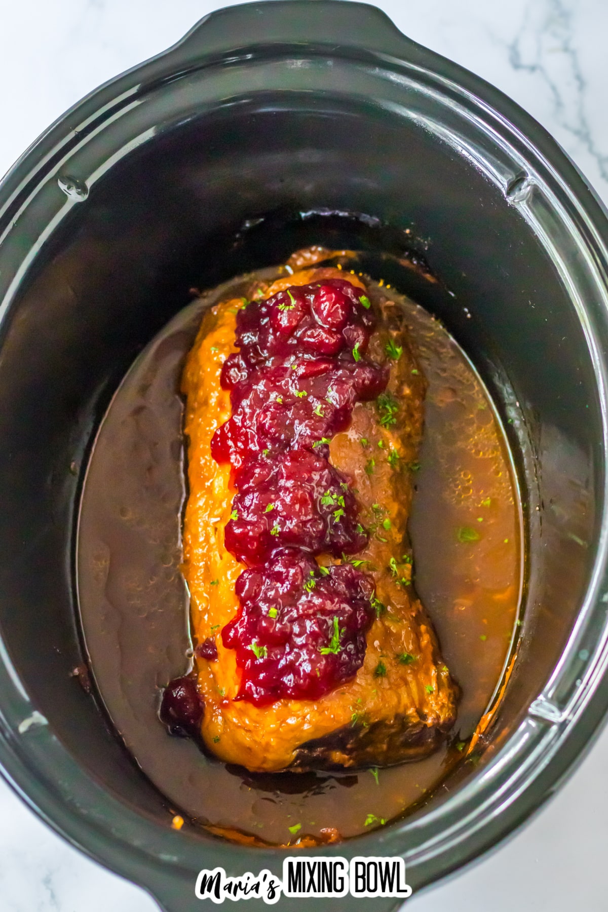 cooked cranberry pork loin in the slow cooker.