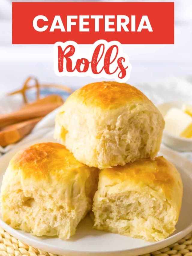 three cafeteria rolls stacked on a small plate.