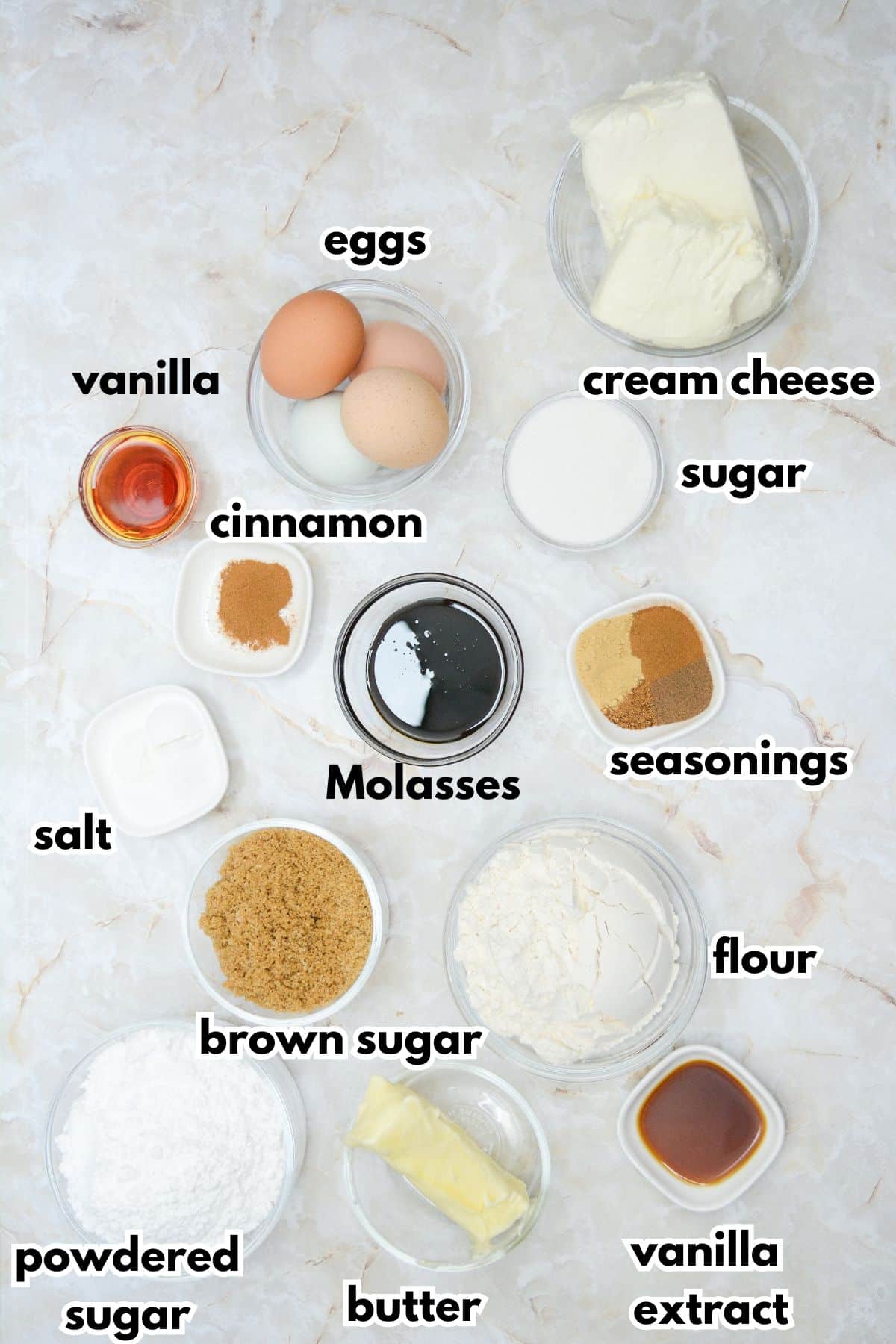 bowls of eggs, cream cheese, vanilla, sugar, cinnamon, molasses, seasonings, salt, brown sugar, flour, powdered sugar, butter, and vanilla extract.