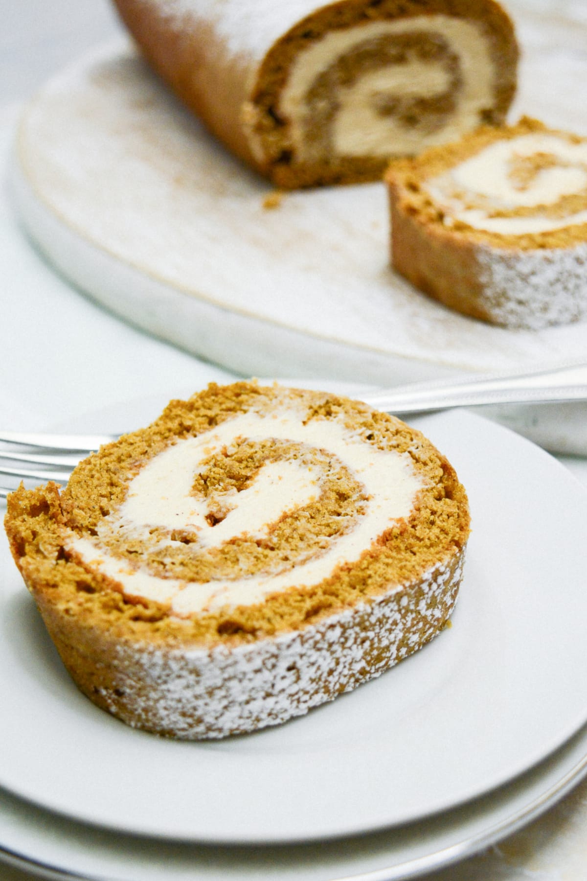 slice of gingerbread cake roll on a plate.