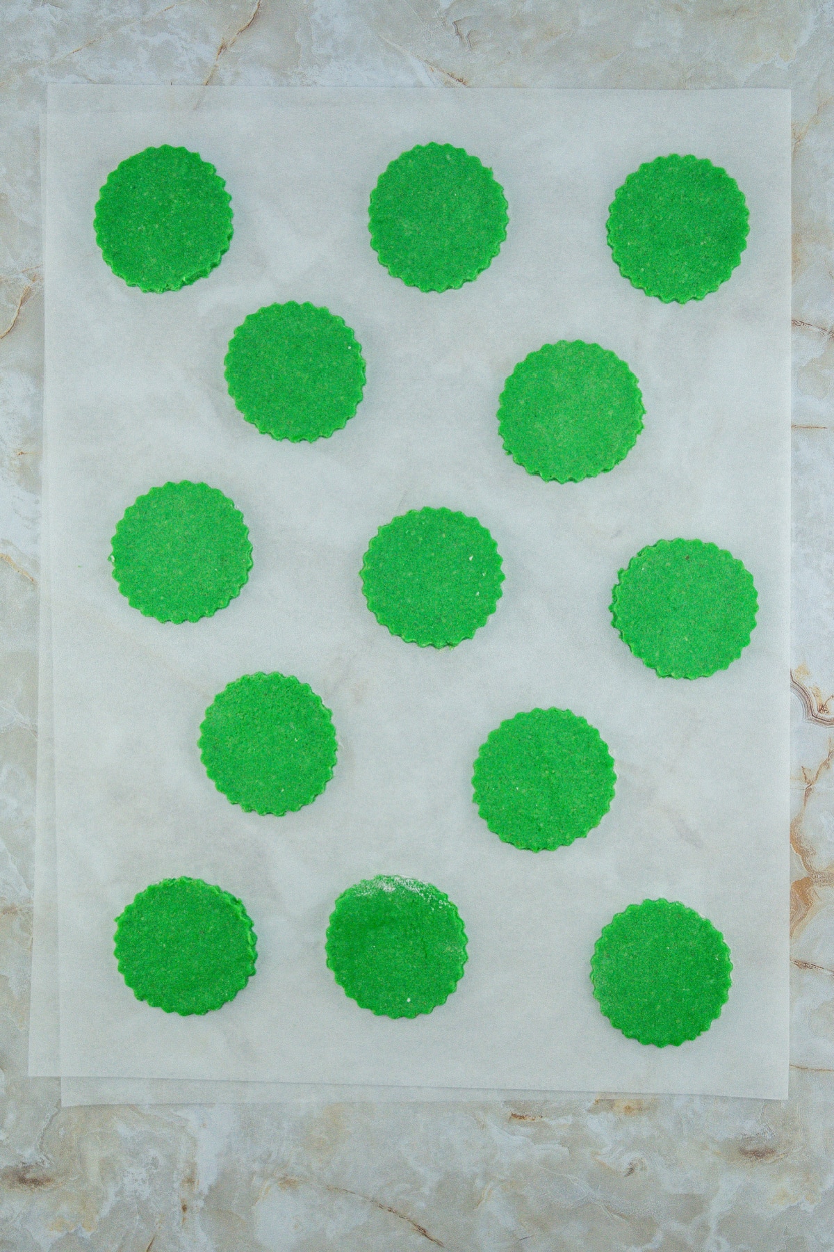 round cookie dough pieces on a parchment paper.