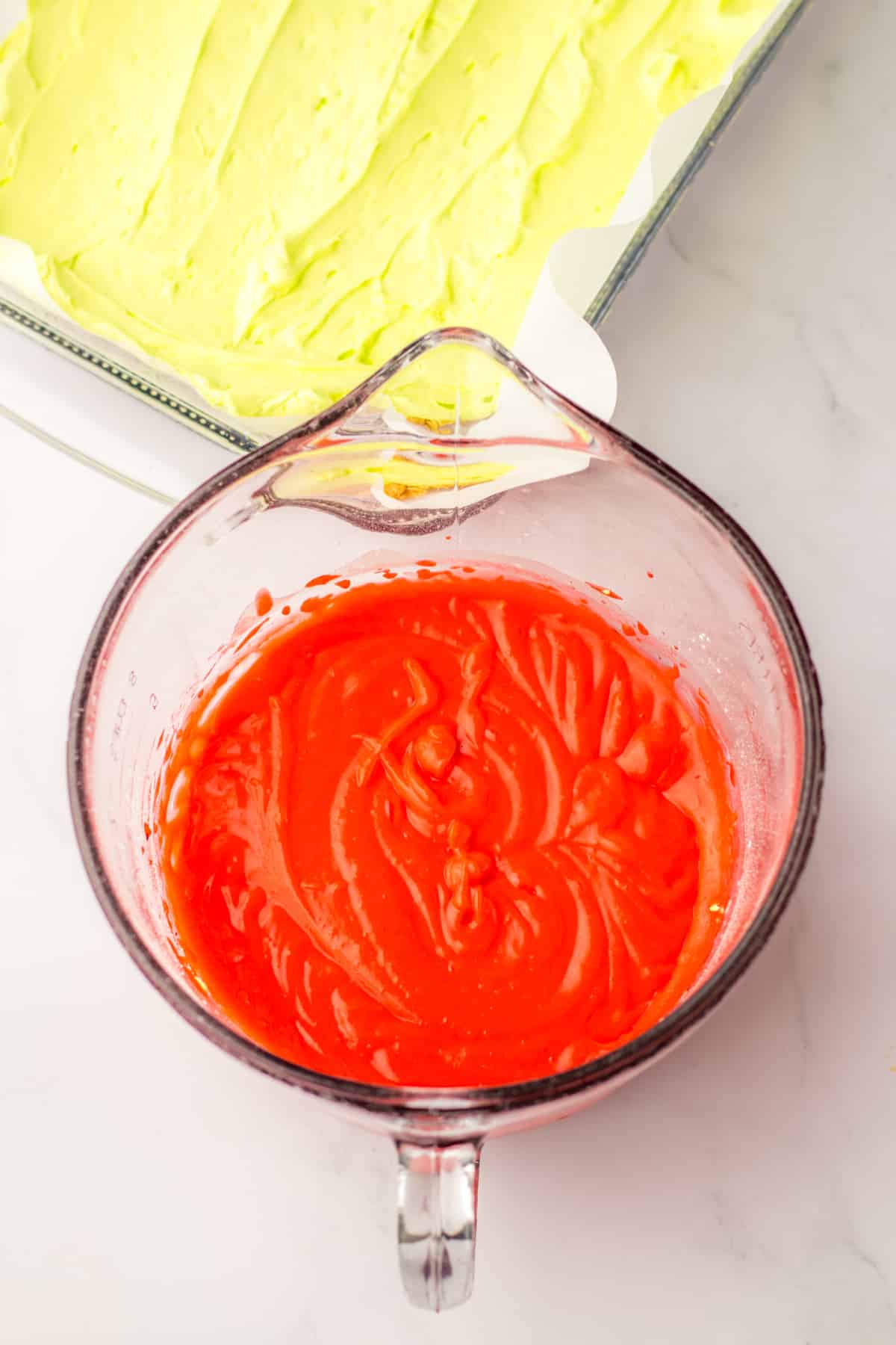 vanilla pudding dyed red on a measuring cup.