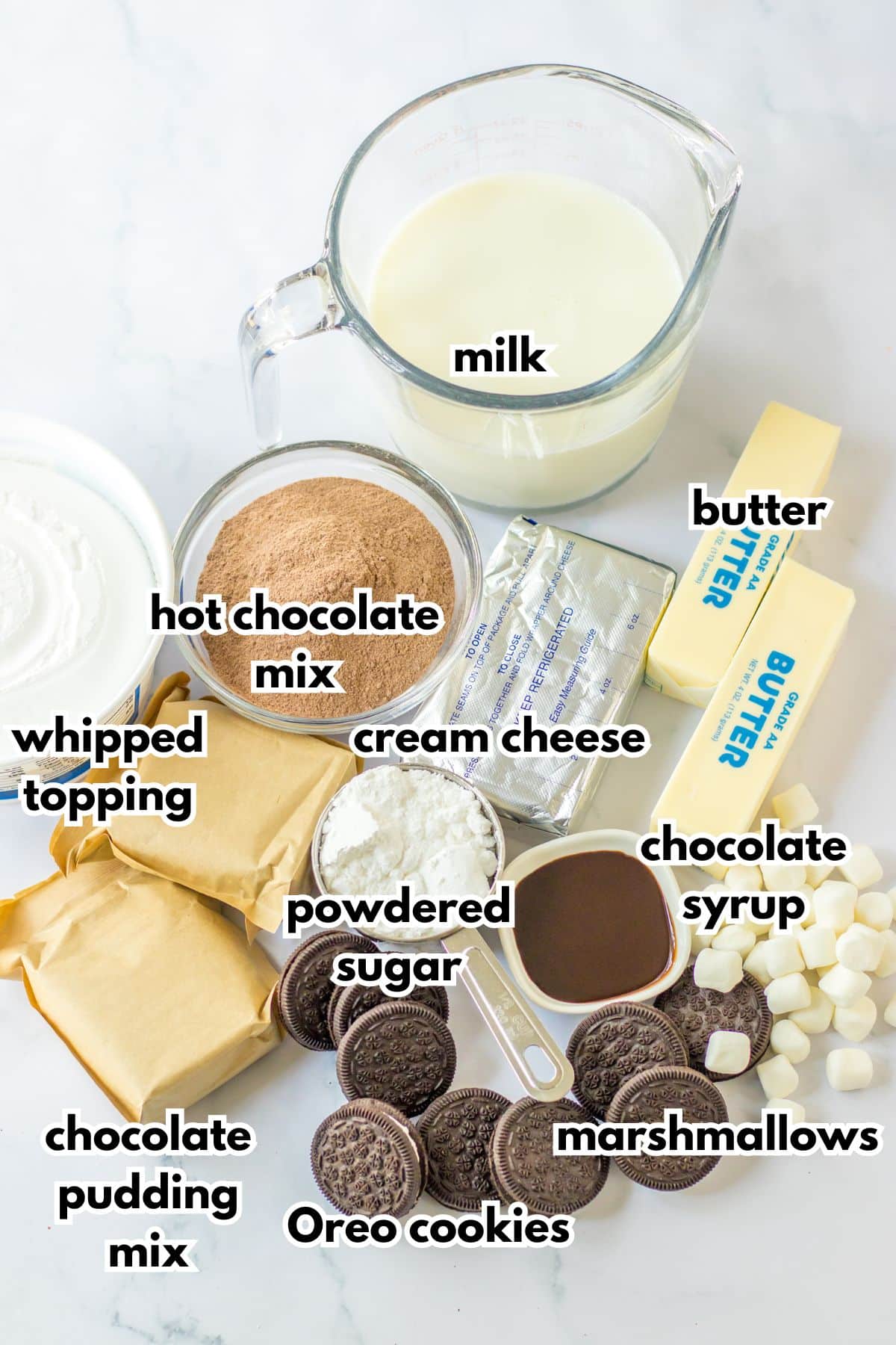 bowls of milk, hot chocolate mix, whipped topping, chocolate pudding mix, powdered sugar, Oreo cookies, marshmallows, butter and chocolate syrup.