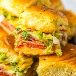 stacks of italian sub sliders on a metal serving tray.