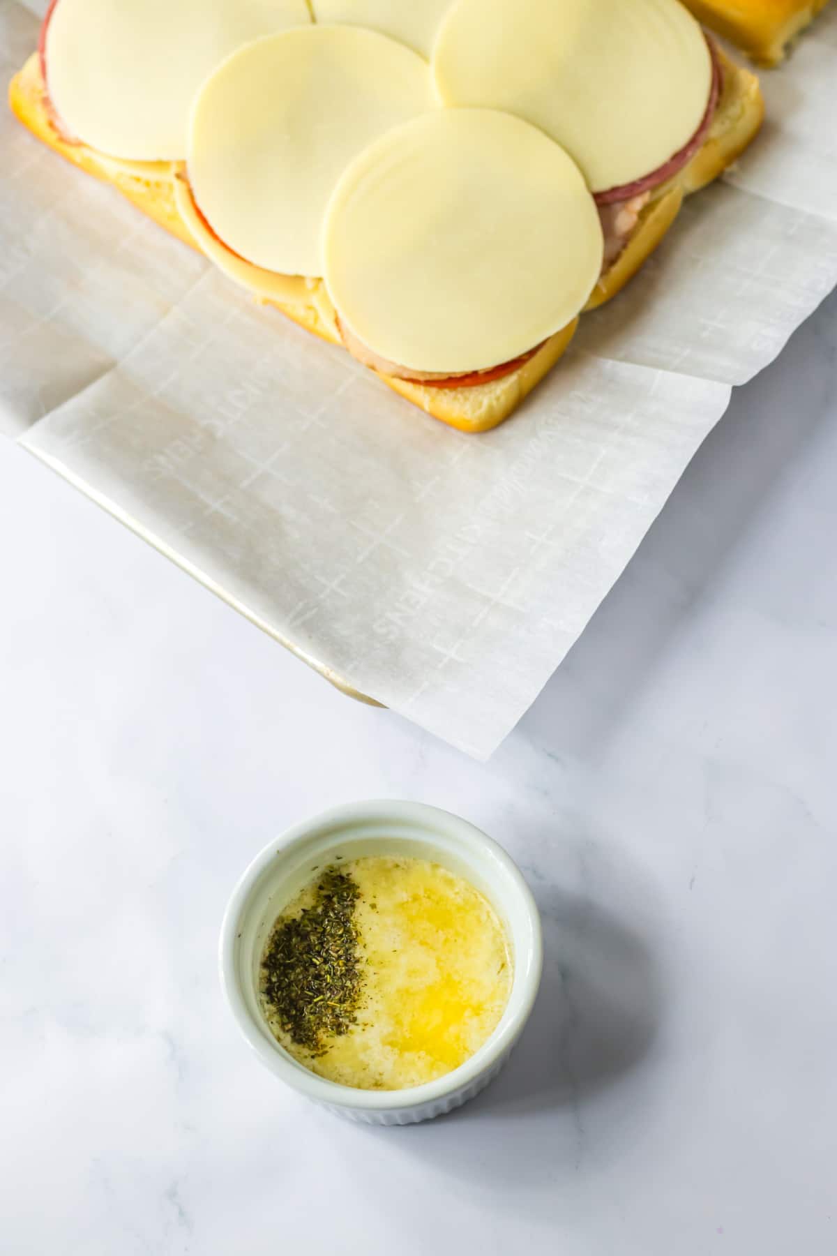 butter and italian seasoning being mixed together.