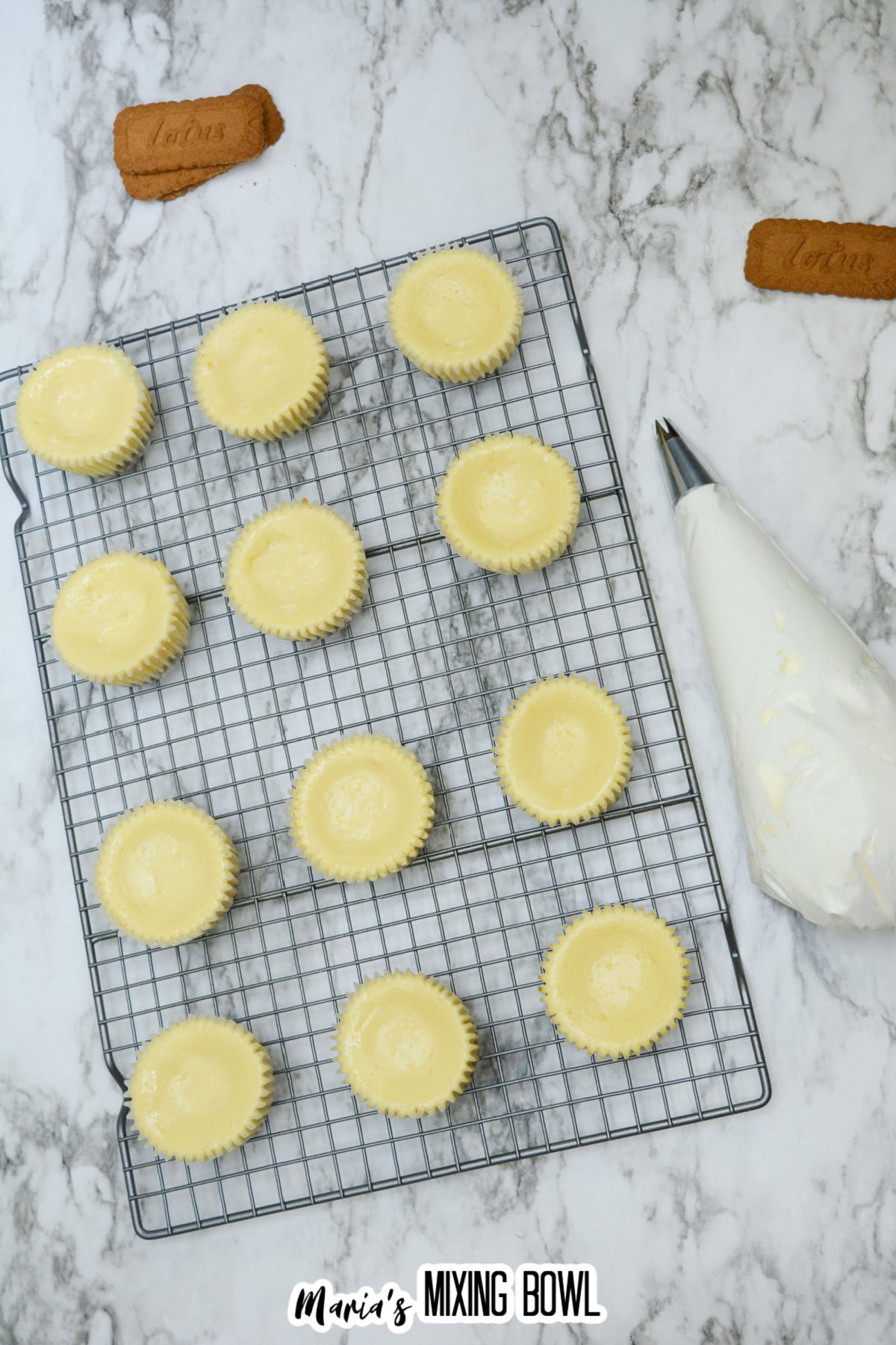 mini biscoff cheesecakes cooling on a wire rack.