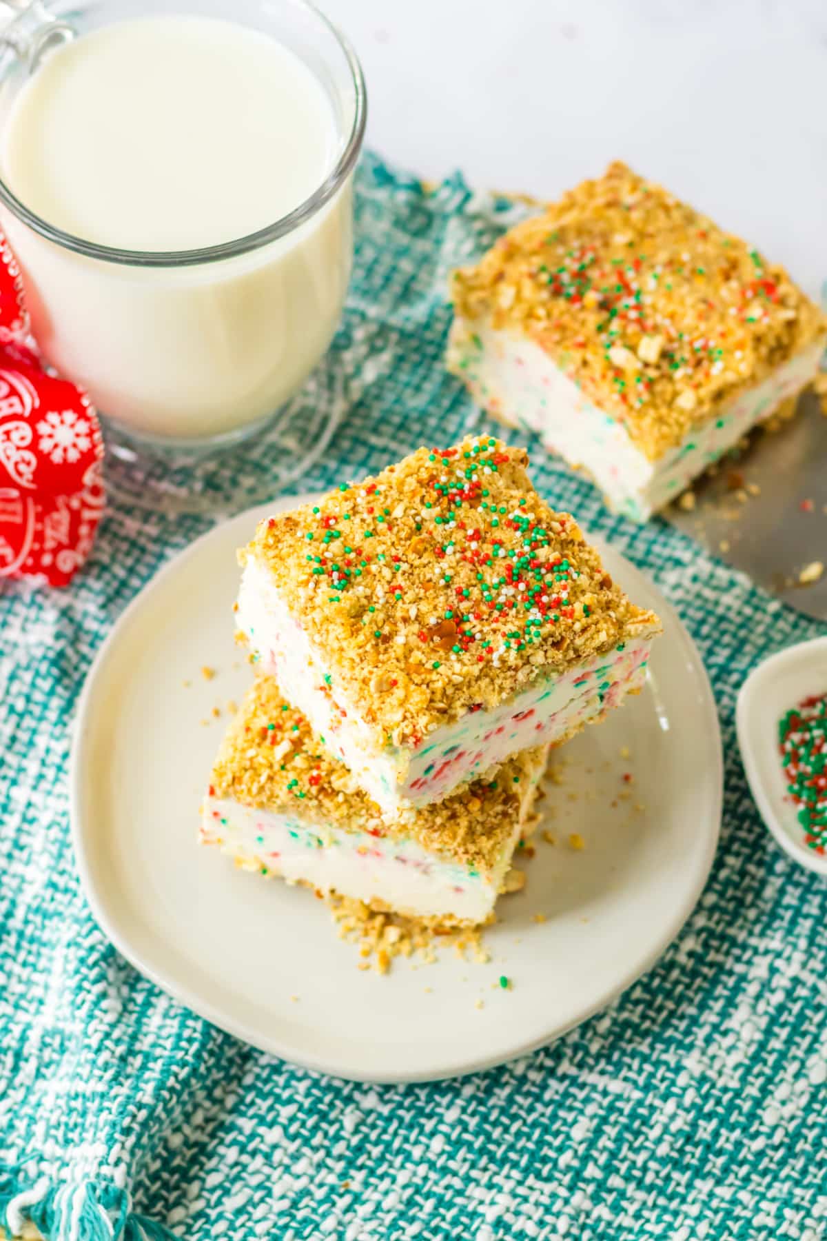 two peppermint crunch cake slices stacked on a small plate.